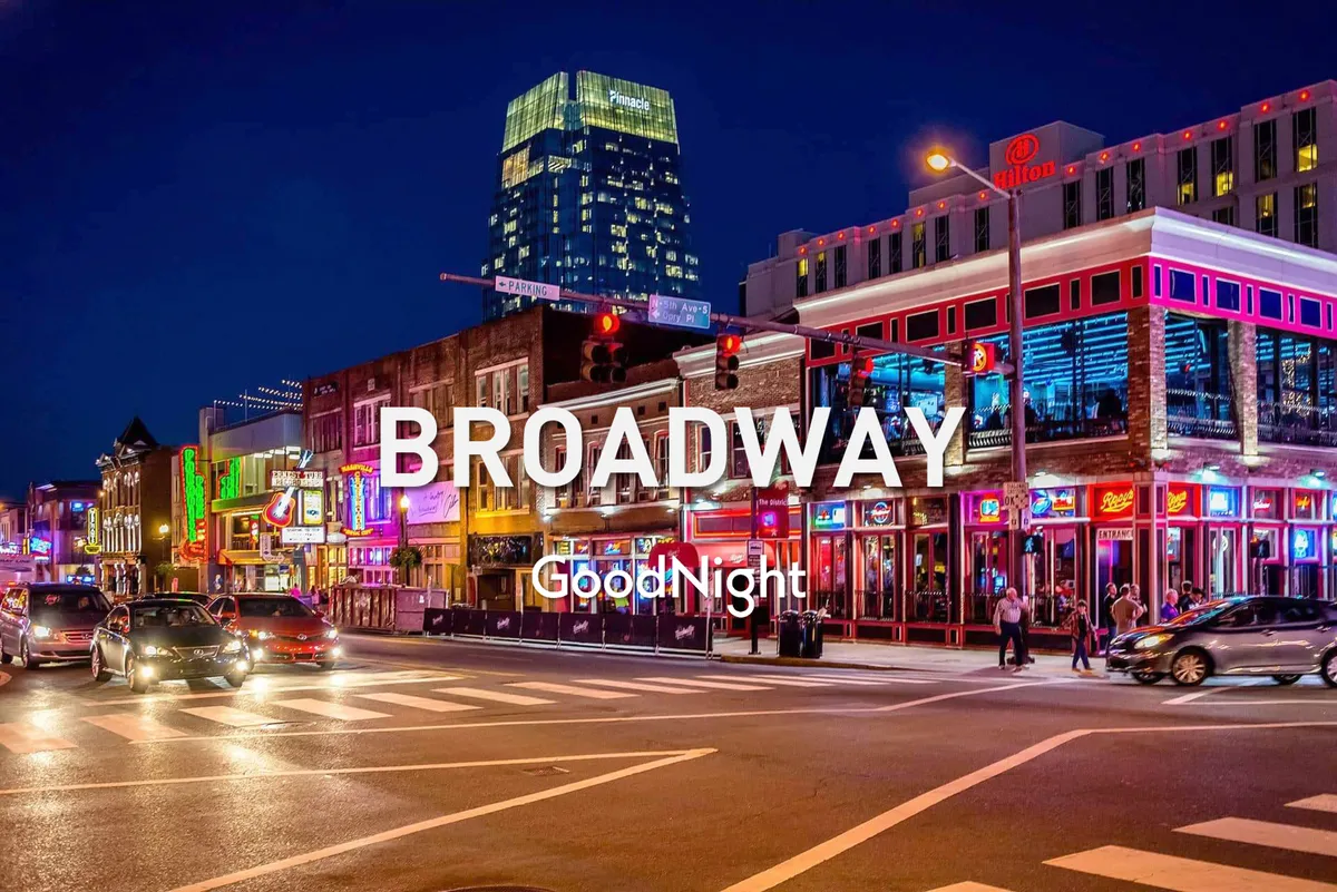 A vibrant street scene featuring neon signs, a busy thoroughfare filled with pedestrians and cars, and a festive nighttime atmosphere. The image channels the spirit of live music, nightlife, and the energetic pulse of Nashville’s entertainment district.