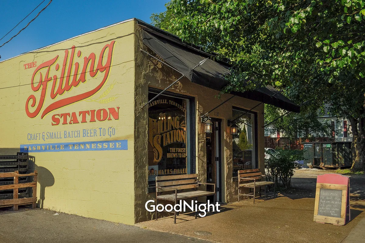 A vibrant exterior scene featuring a large, colorful wall mural as the focal point, with an inviting outdoor seating area and playful signage. People are casually gathered, enjoying drinks and socializing, capturing the dynamic, creative spirit of Nashville’s neighborhoods.